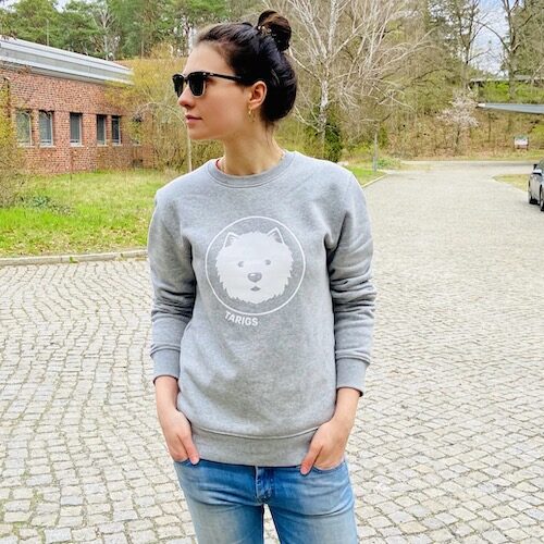 Woman wearing light gray sweatshirt with Westie motif